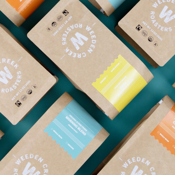 Weeden Roasters coffee packages on a teal background