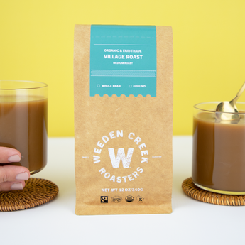 Weeden Creek Roasters coffee bag with a glass of coffee on a yellow background