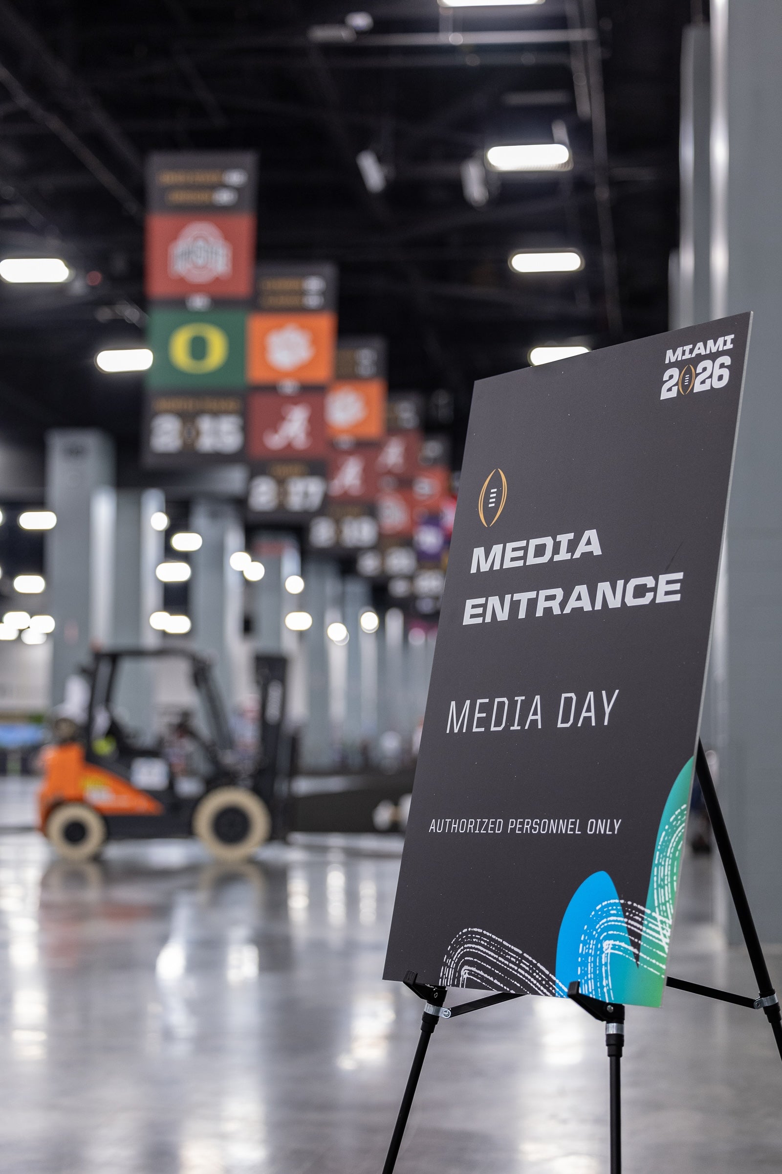Media entrance sign at a media day event with blurred background of indoor venue.