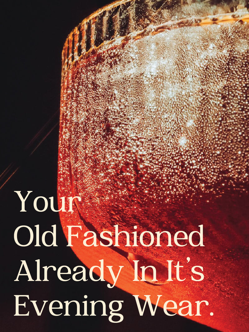 Close-up of a glass with red liquid and text overlay on a dark background