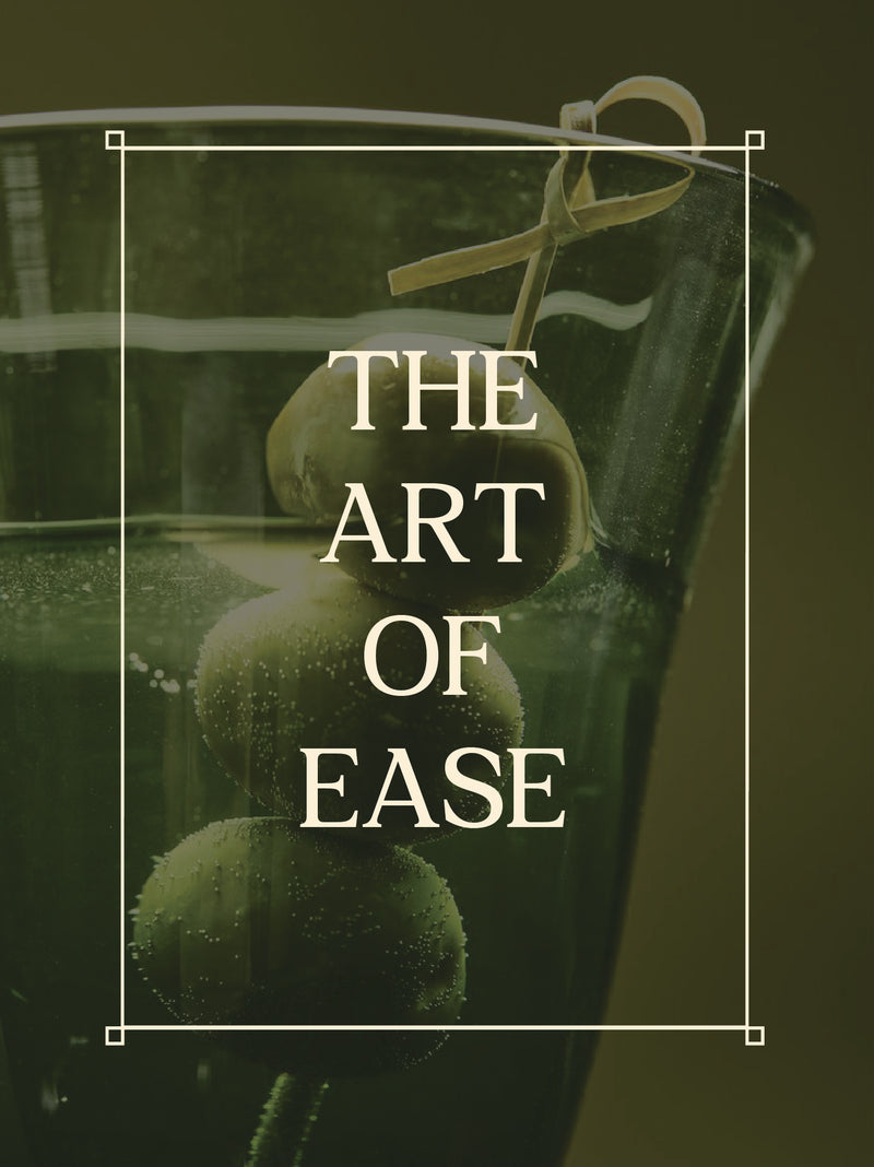 Mojito cocktail with olives in a glass, text 'THE ART OF EASE' overlayed.