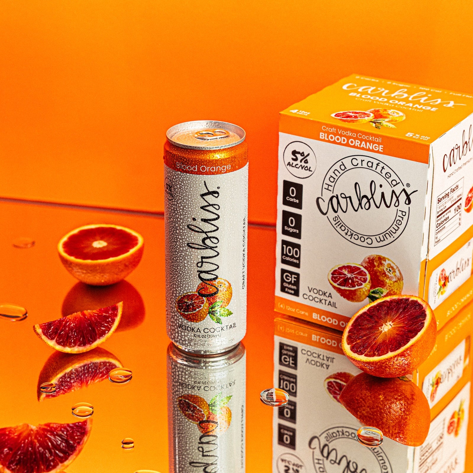 Carbliss blood orange cocktail can and box on an orange background