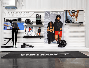 Gymshark store interior with promotional posters and products.